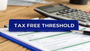 Tax-free threshold concept with paperwork, calculator, and pen on desk