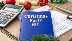 Christmas Party FBT booklet on a desk with calculator, tax documents and festive decorations, representing Australian Fringe Benefits Tax rules for Christmas parties.