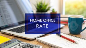 A home office setup with a laptop, calculator, notebook and coffee mug on a desk, with a blue banner displaying the text “Home Office Rate”.